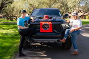 Two girls promoting el patron t-shirts in front of ram truck