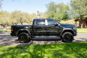 Side view of black truck parked roadside