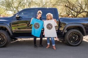 Long shot of two girls standing near the truck