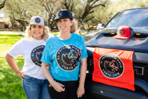 Two girls standing near truck wearing El patron t-shirt